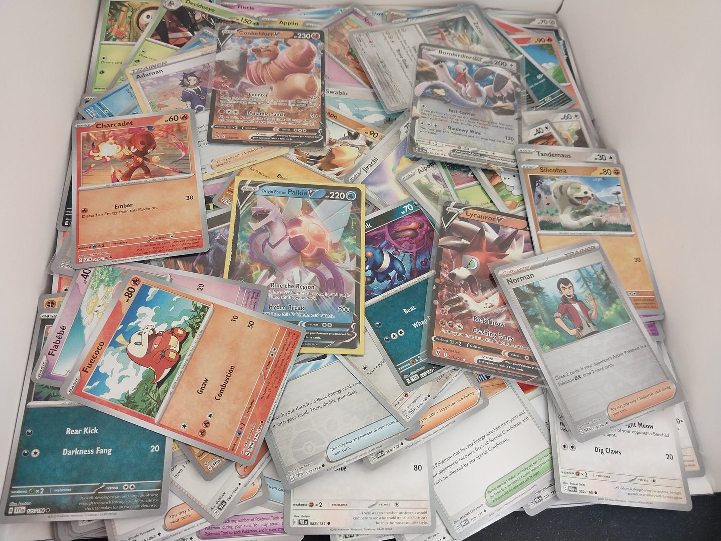 Collection of various trading cards on a white surface