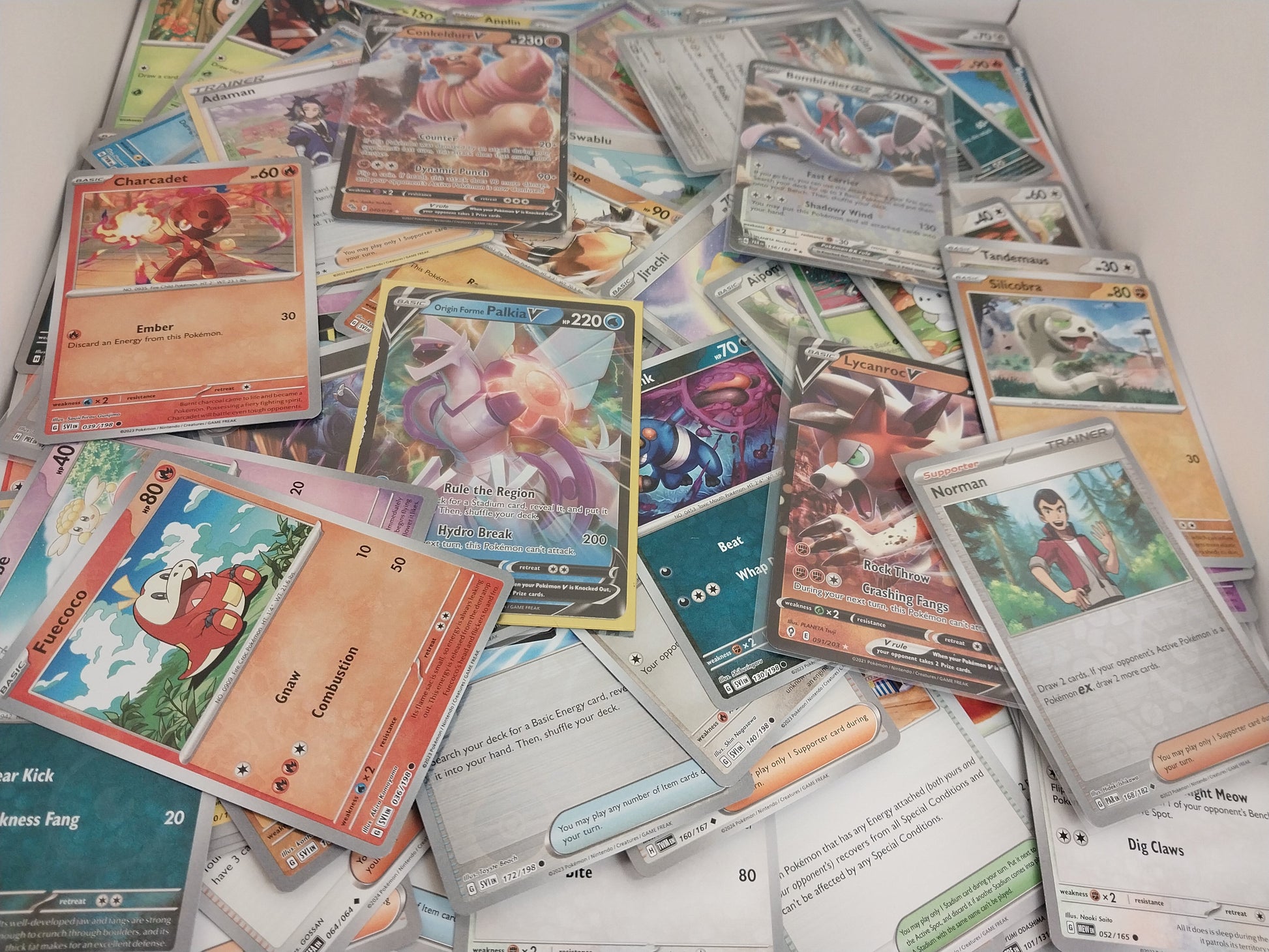 Collection of various trading cards on a white surface