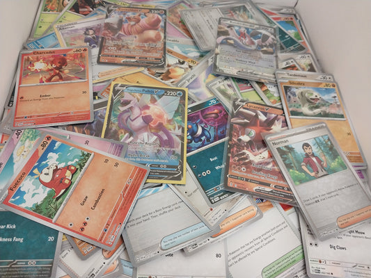Collection of various trading cards on a white surface