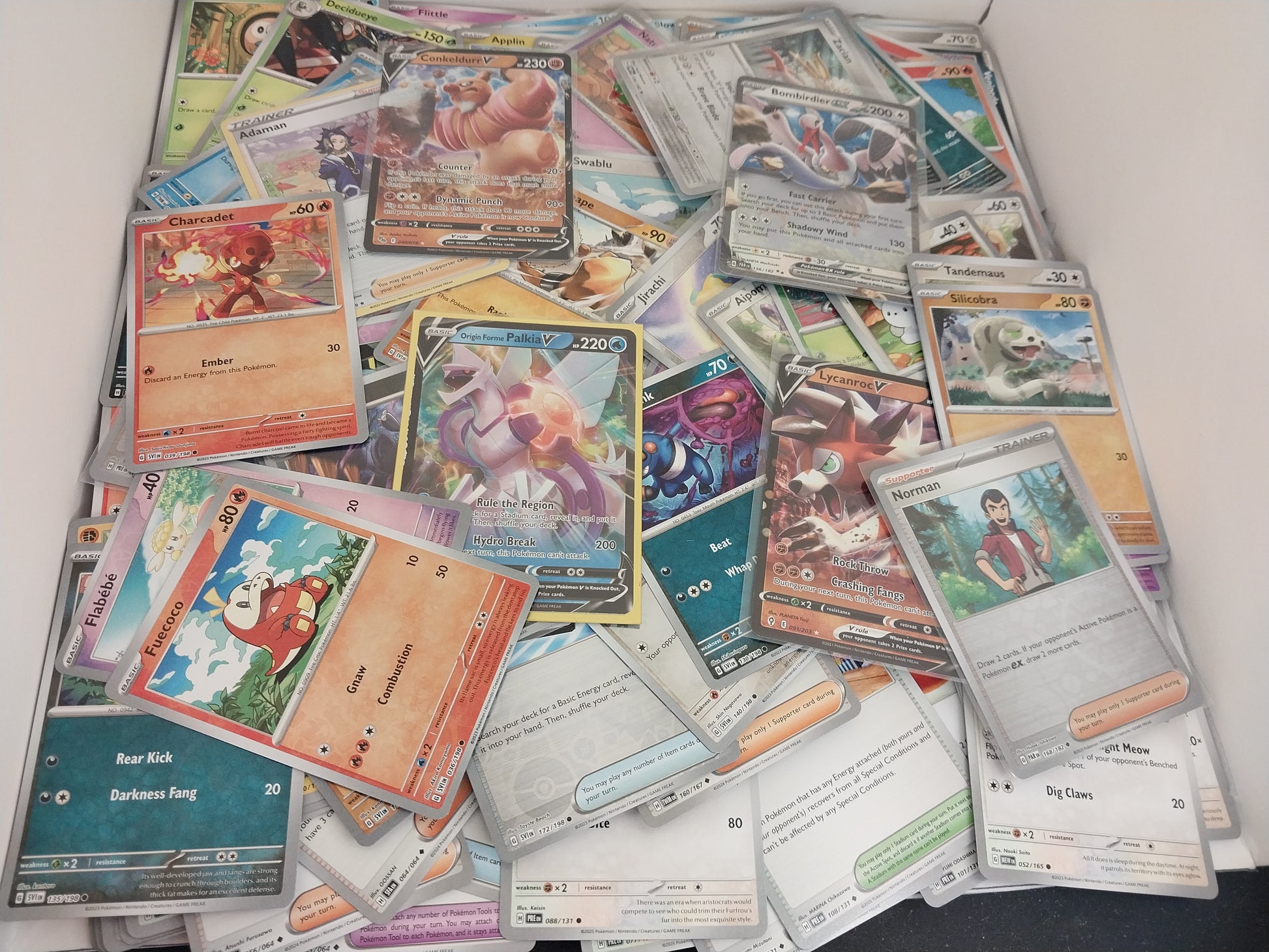 Collection of various trading cards on a white surface